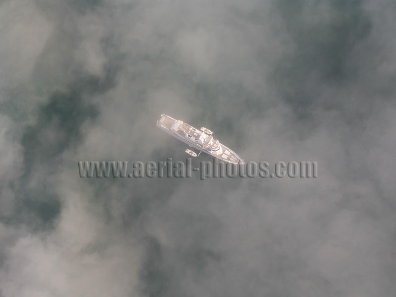 AERIAL VIEW photo of a boat in fog. Malibu, Los Angeles, California, United States.