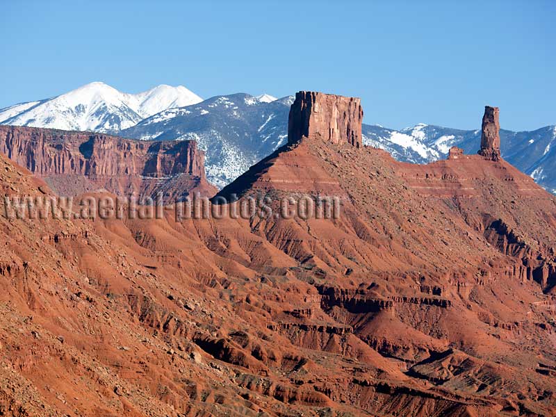 Aerial view of Castleton Tower and La Sal Mountains, Castle Valley, Utah, USA.