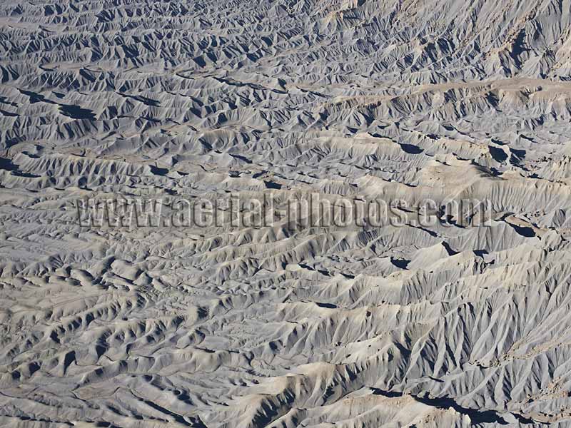 AERIAL VIEW photo of a desertic landscape, badlands near Caineville, Utah, United States.