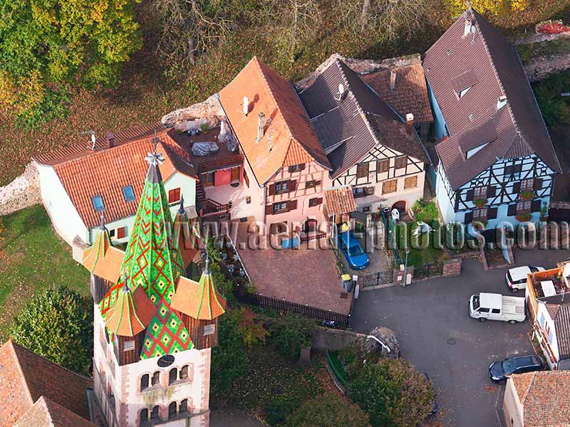 Aerial photo of a steeple and half-timbered houses in Châtenois, Bas-Rhin, Alsace, Grand Est, France. Vue aérienne. Maisons à colombages.