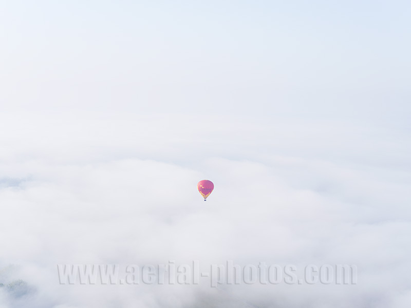 Aerial photo of a hot-air balloon above the fog. Grand Est, France. Vue aérienne.