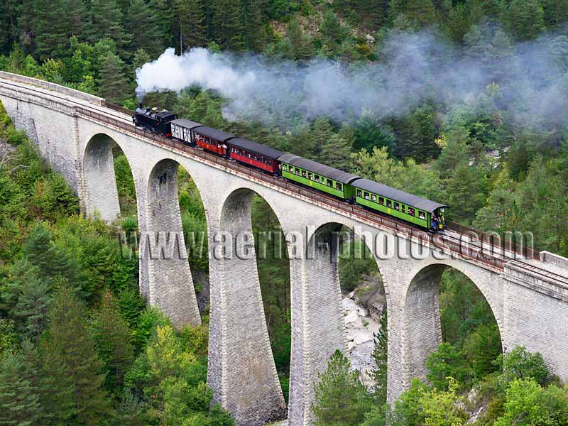 AERIAL VIEW photo of steam train, Train des Pignes, Entrevaux, French Alps, France. VUE AERIENNE train à vapeur, Alpes Françaises.