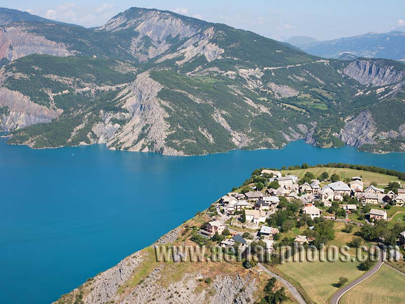 Aerial view of Le Sauze-du-Lac, a small village overlooking Lake Serre-Ponçon in the Alps, France. Vue aérienne.
