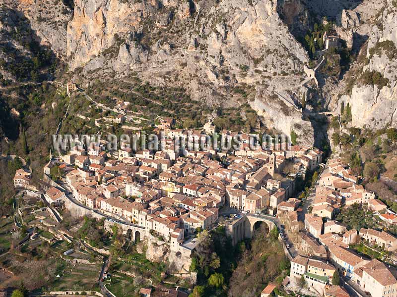 AERIAL VIEW photo of a foothill village, Moustiers-Sainte-Marie, Provence, France. VUE AERIENNE.