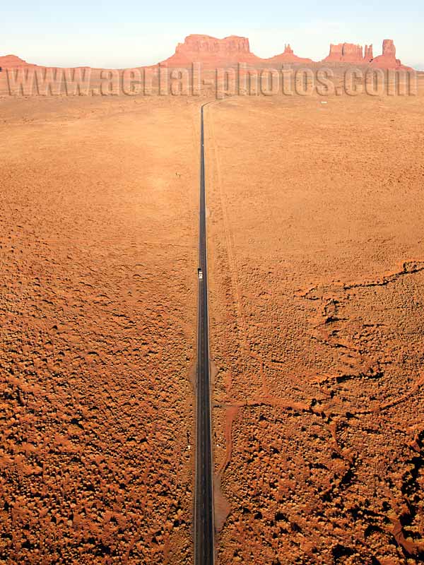 Aerial view of a straight road in Monument Valley, Navajo Land, Arizona and Utah, USA.