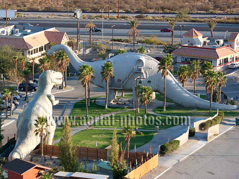 Aerial view of road side attraction alongside Interstate 10, tyrannosaur and brontosaur, Cabazon, California, USA.