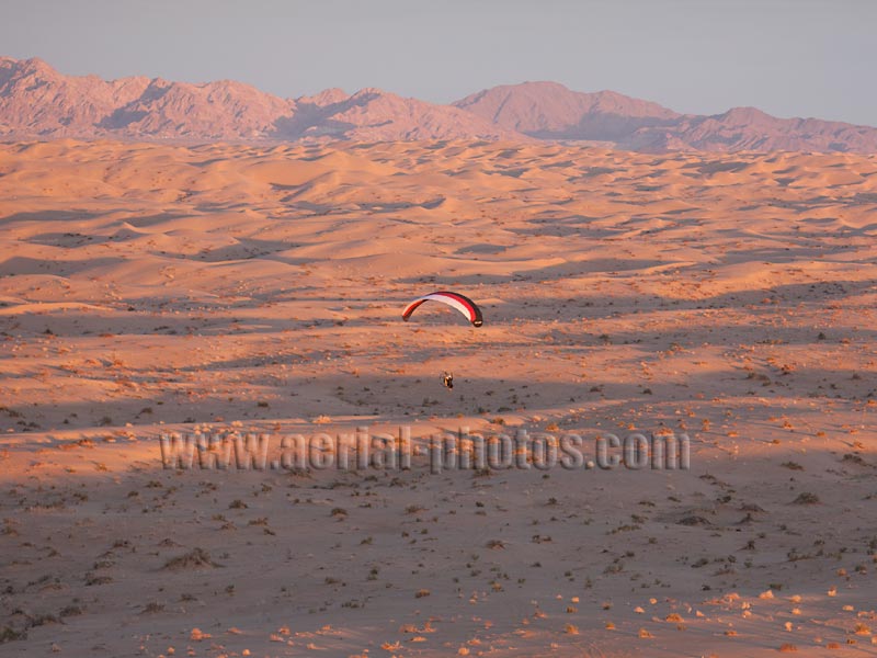 Aerial view of a mororized paraglider or paramotor over the Algodones Dunes. Sonoran Desert, California, USA.