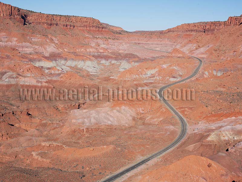 Aerial view of a winding road in red rock formations, Clay Hills, Utah, Colorado Plateau, USA.